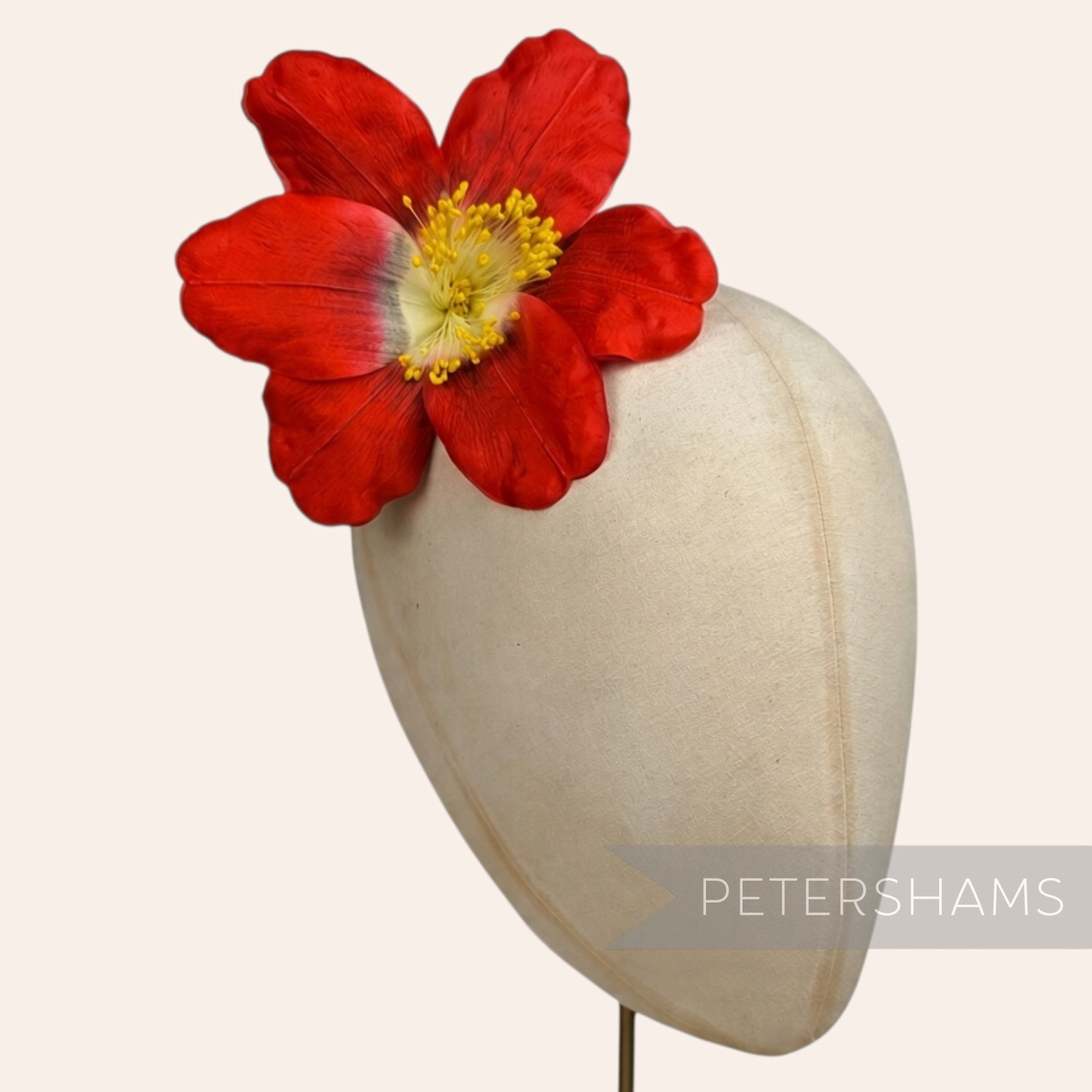 Petershams Millinery Supplies vintage red silk hibiscus flower with long yellow stamens on a millinery head block
