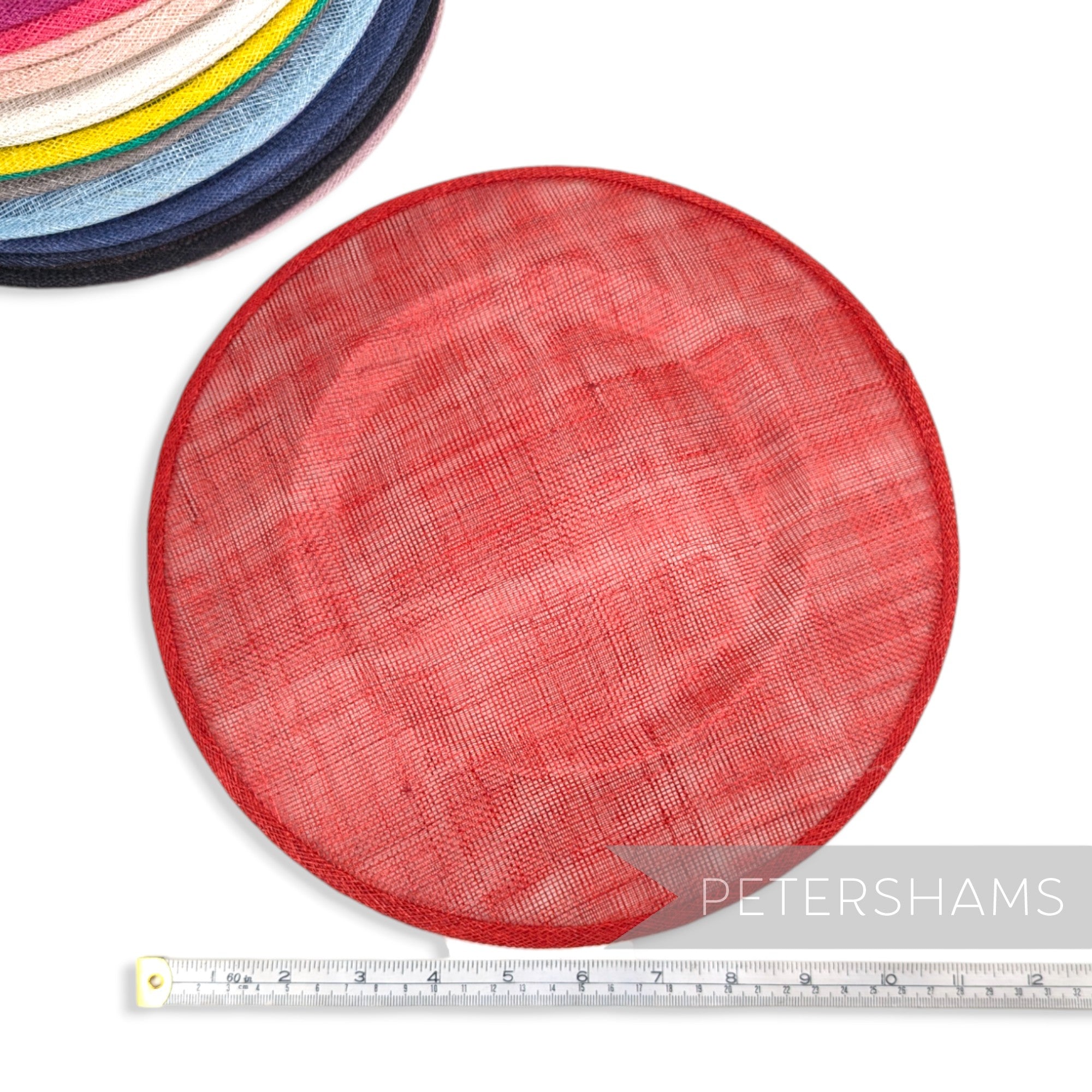 Petershams Millinery Supplies red 29cm round sinamay fascinator hat base with a stack of other colours in background