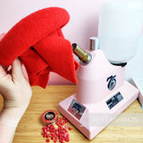 Petershams Millinery Supplies red thermoformable wool felt fabric being steamed by a pink Jiffy steamer for millinery