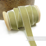 Petershams Millinery Supplies 16mm sage green elastic stretch velvet ribbon on a wooden spool for millinery projects.