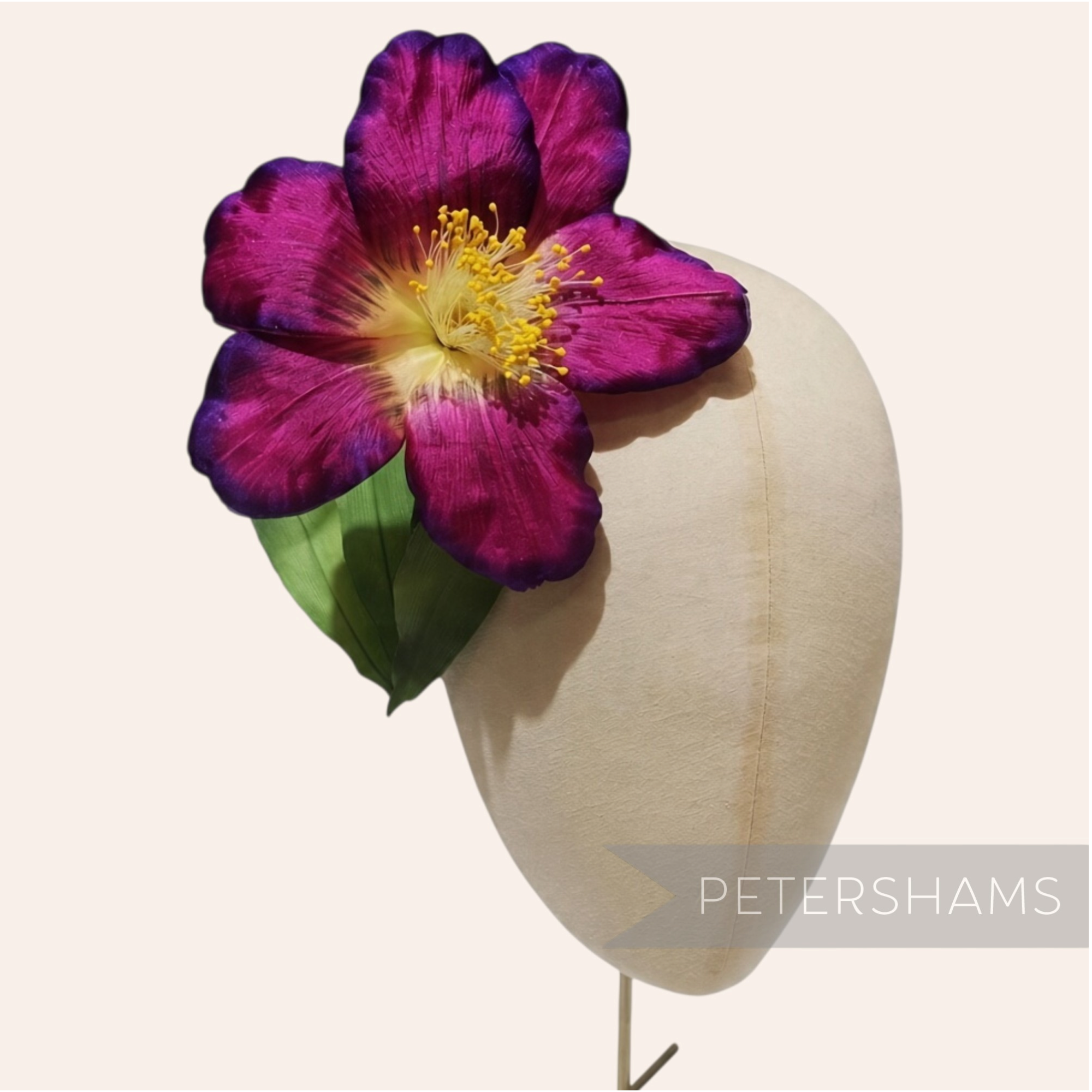Petershams Millinery Supplies vintage German silk hibiscus flower in deep purple with yellow stamens on a display head