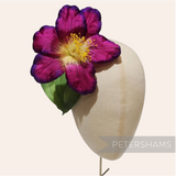Petershams Millinery Supplies vintage German silk hibiscus flower in deep purple with yellow stamens on a display head