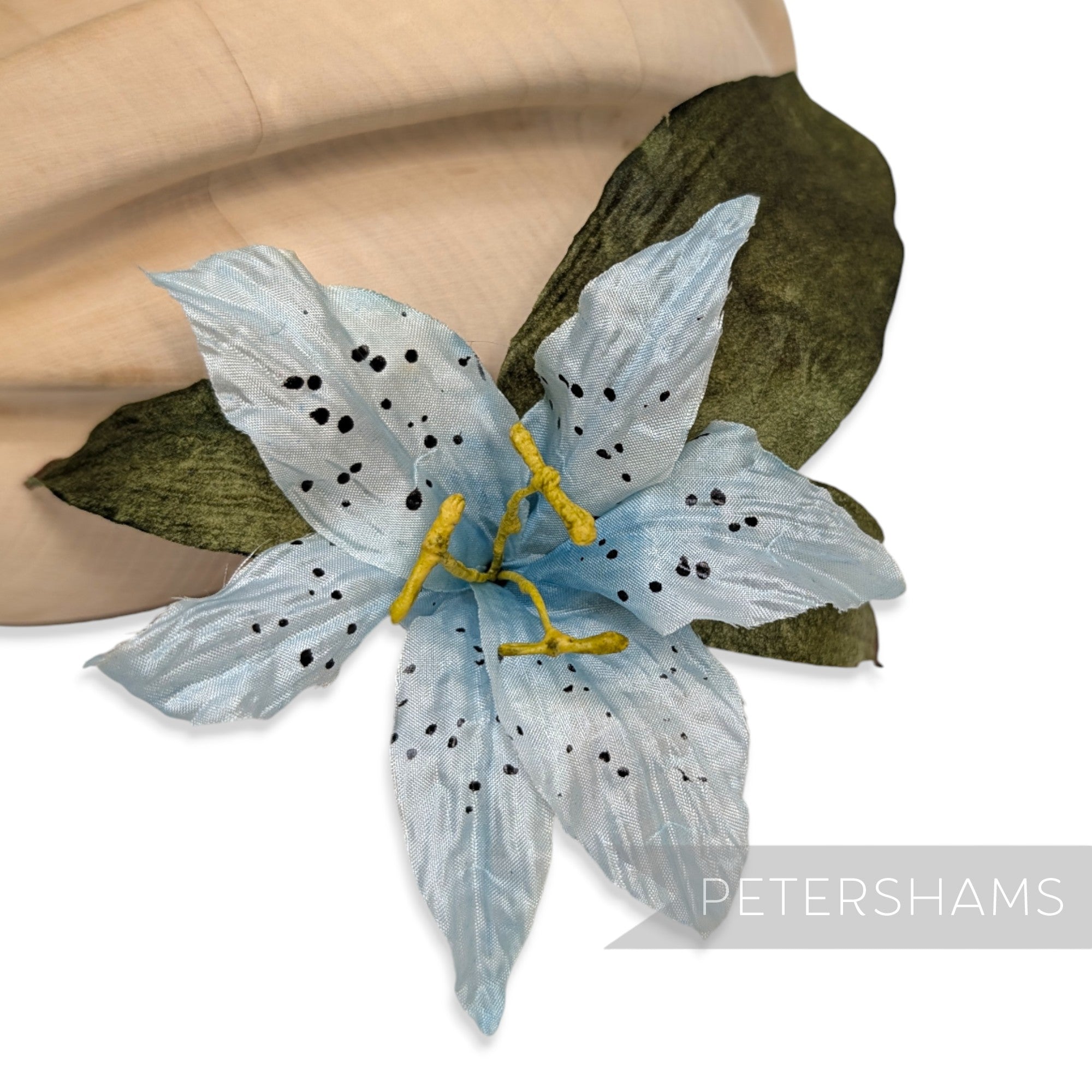 Petershams Millinery Supplies vintage 1980s silk lily hat mount with blue spotted petals and green paper mesh leaves.