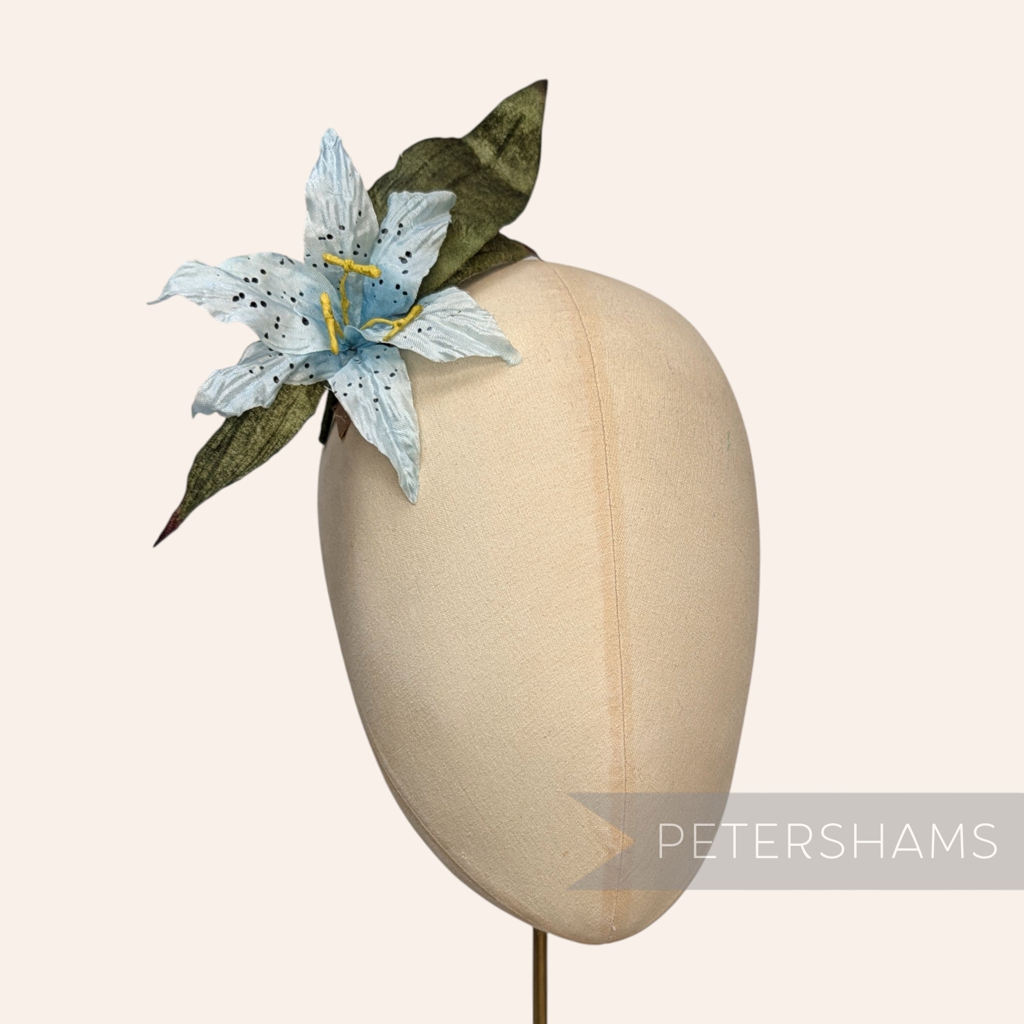 Petershams Millinery Supplies vintage silk lily hat mount with gradient blue petals and green paper mesh leaves.
