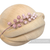 Petershams Millinery Supplies Giselle mini silk wired rosebud hat mount in soft pink on a wooden millinery block