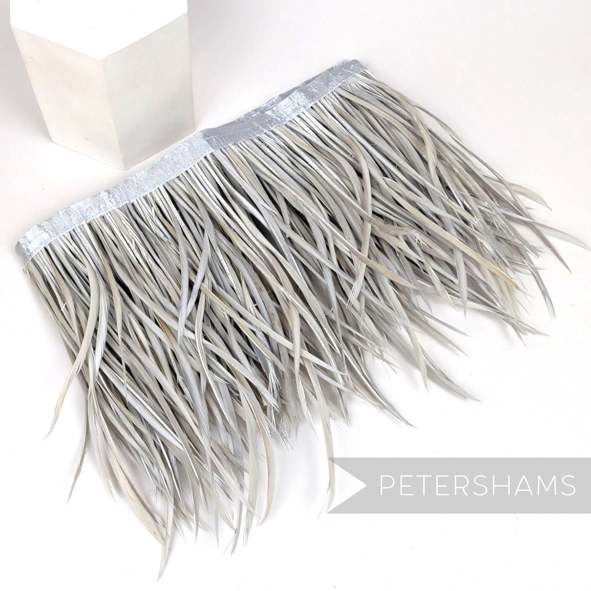 Petershams Millinery Supplies extra long silver grey goose biot feather fringe on a satin ribbon binding.