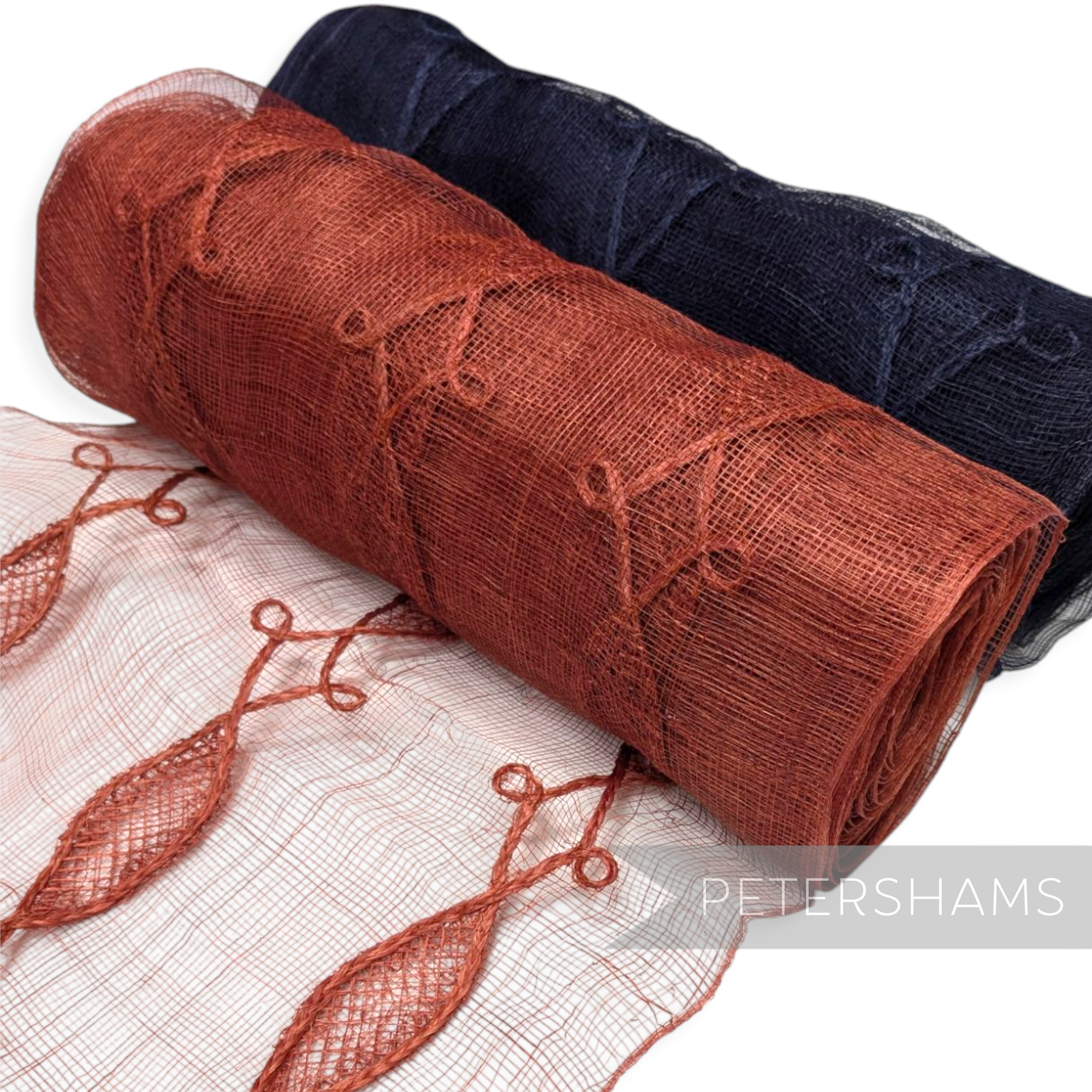 Petershams Millinery Supplies rolls of rust and navy blue Renaissance swirl applique sinamay fabric trim.