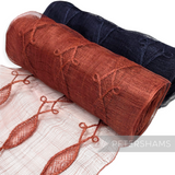 Petershams Millinery Supplies rolls of rust and navy blue Renaissance swirl applique sinamay fabric trim.