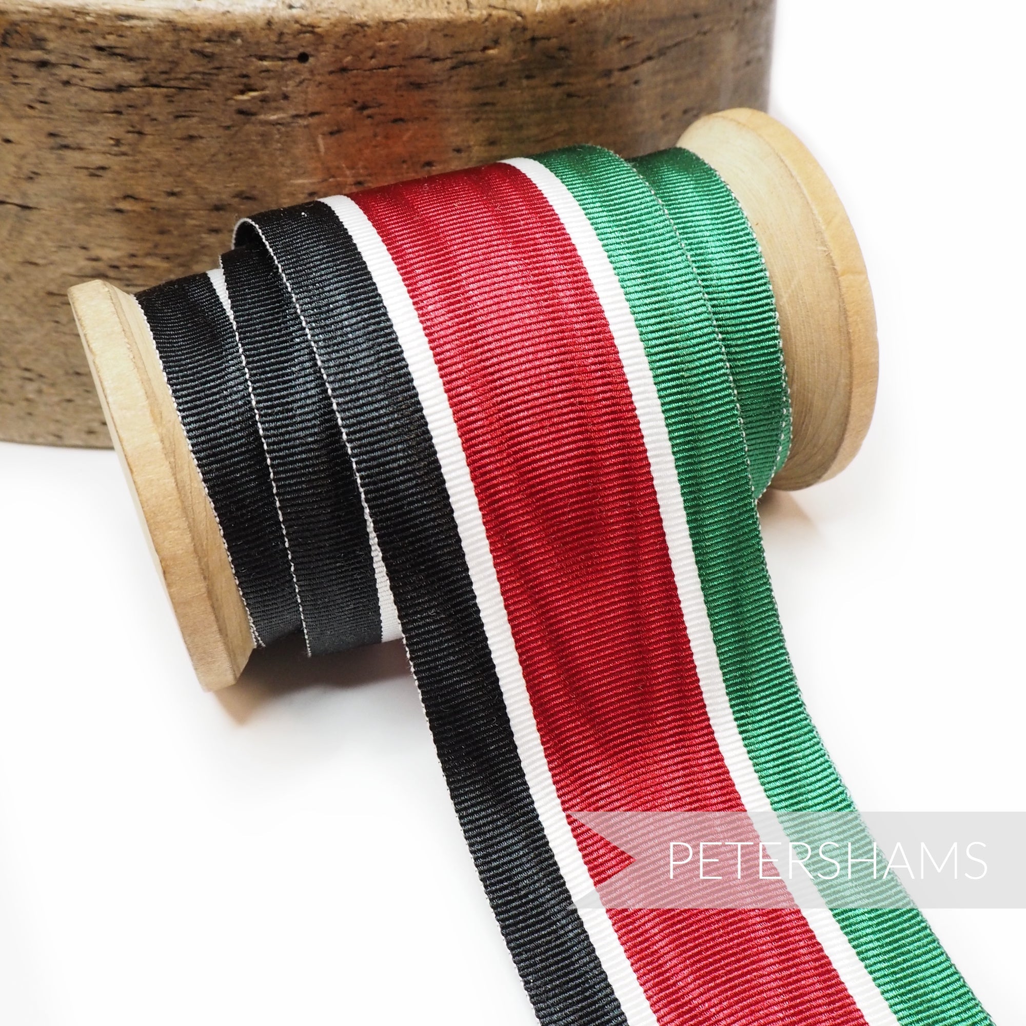 Petershams Millinery Supplies vintage 45mm striped grosgrain ribbon in black, red, white, and green on a wooden spool.