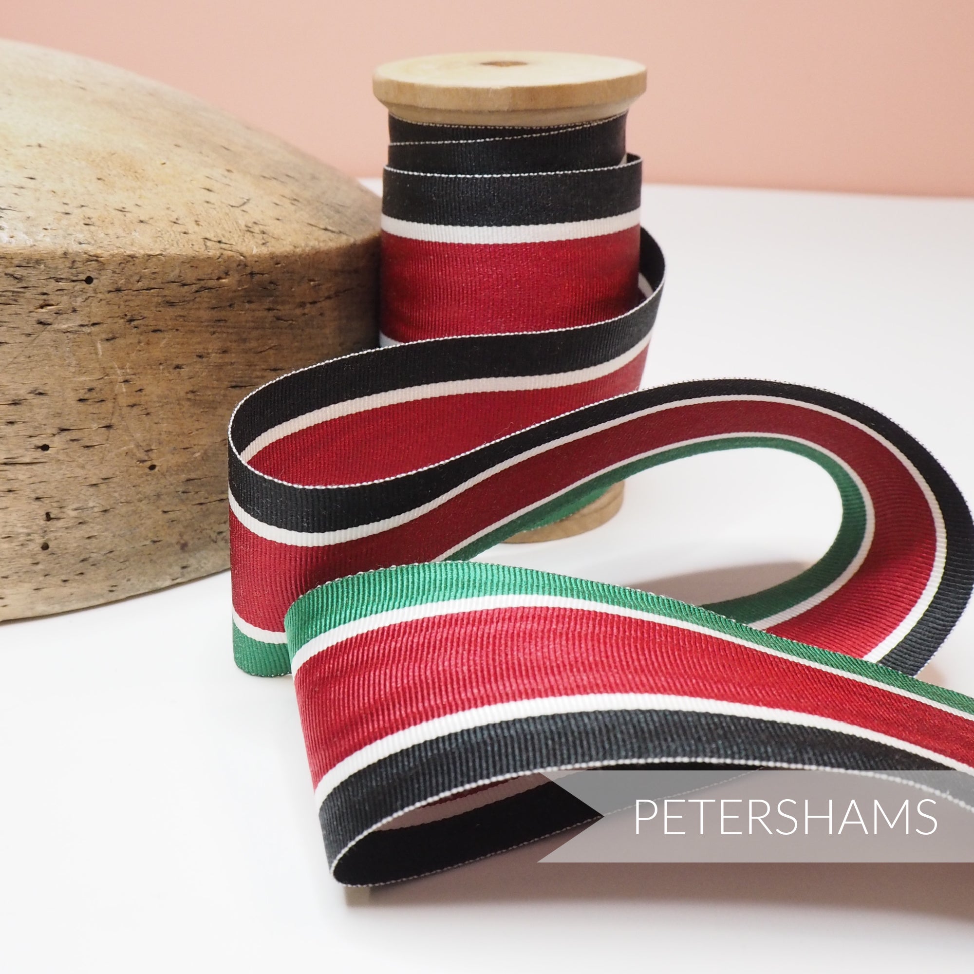 Petershams Millinery Supplies vintage 45mm striped grosgrain ribbon in red, black, white, and green on a wooden spool.