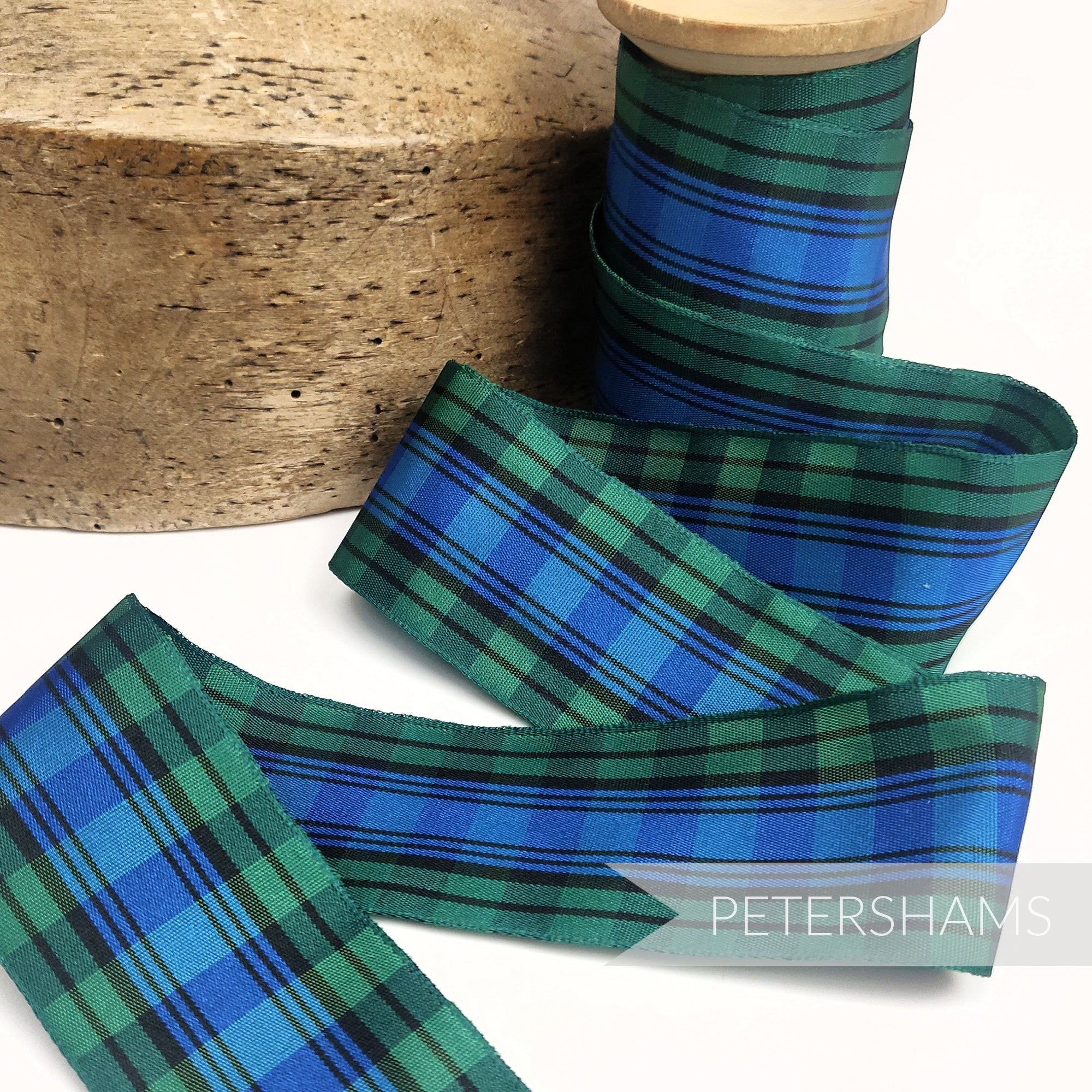 Petershams Millinery Supplies 40mm blue and green tartan woven edge polyester ribbon on a wooden spool