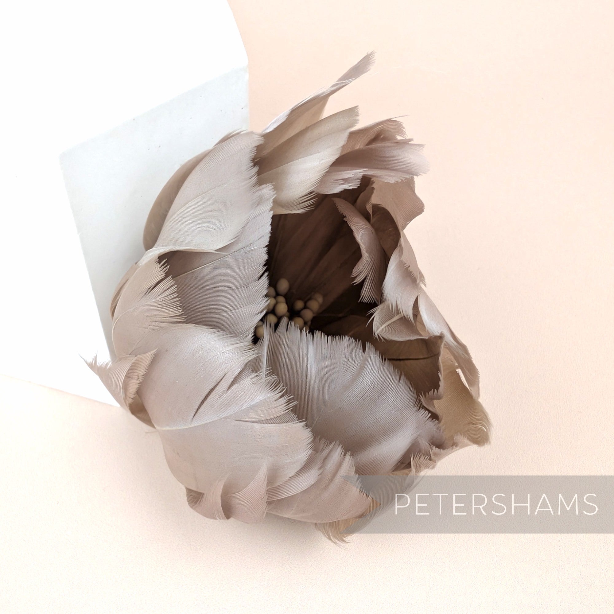 Petershams Millinery Supplies large tulip-shaped flower made from taupe goose nagorie feathers with central stamens.