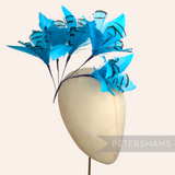Petershams Millinery Supplies turquoise lady amherst and goose feather flower hat mount on a millinery head block