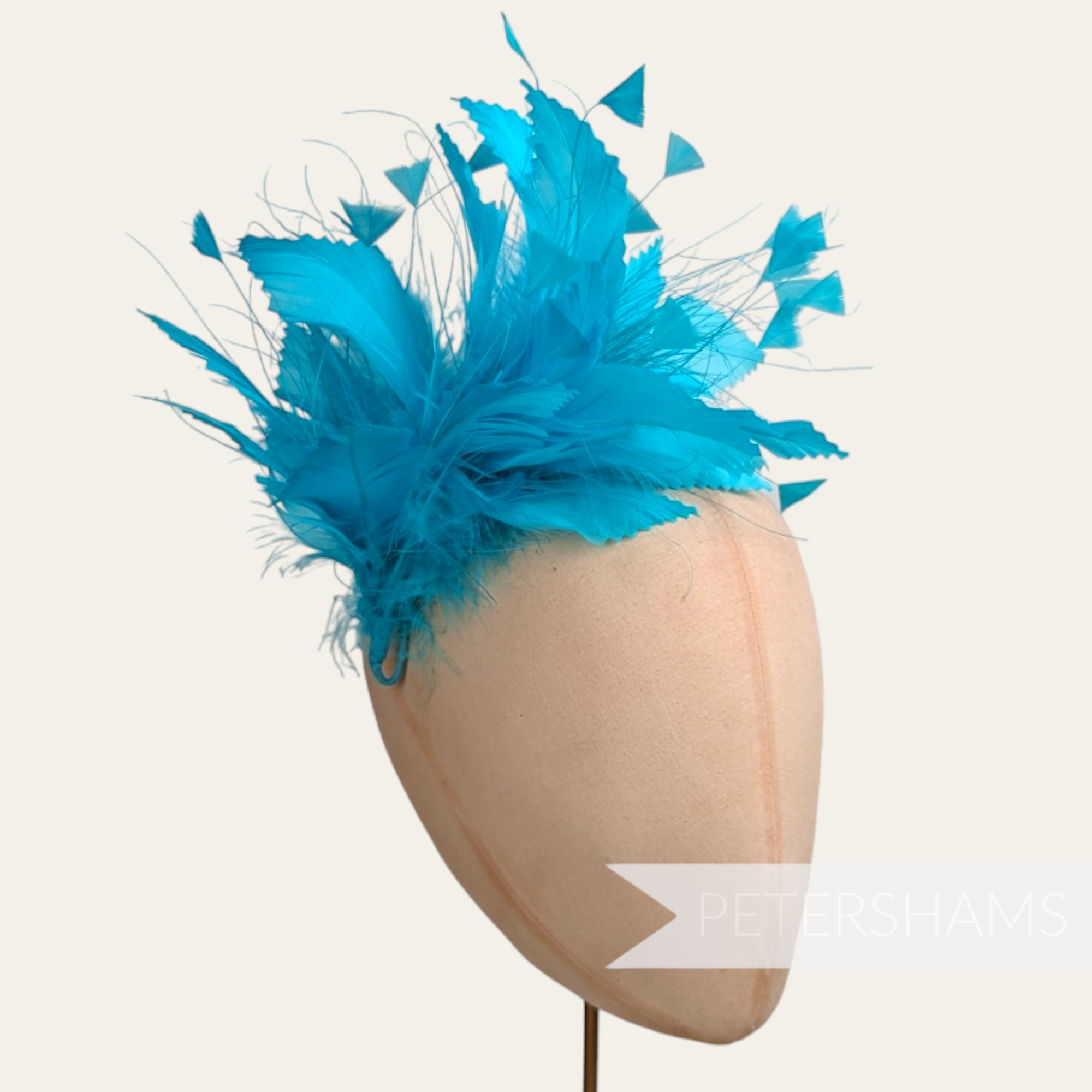 Petershams Millinery Supplies bright turquoise feather hat mount with zig zag goose and peacock feathers