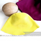 Petershams Millinery Supplies extra large peachbloom velour fur felt hat cones in bright yellow and deep purple.