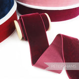 Petershams Millinery Supplies 50mm burgundy French velvet ribbon on a wooden spool with a luxurious sheen.