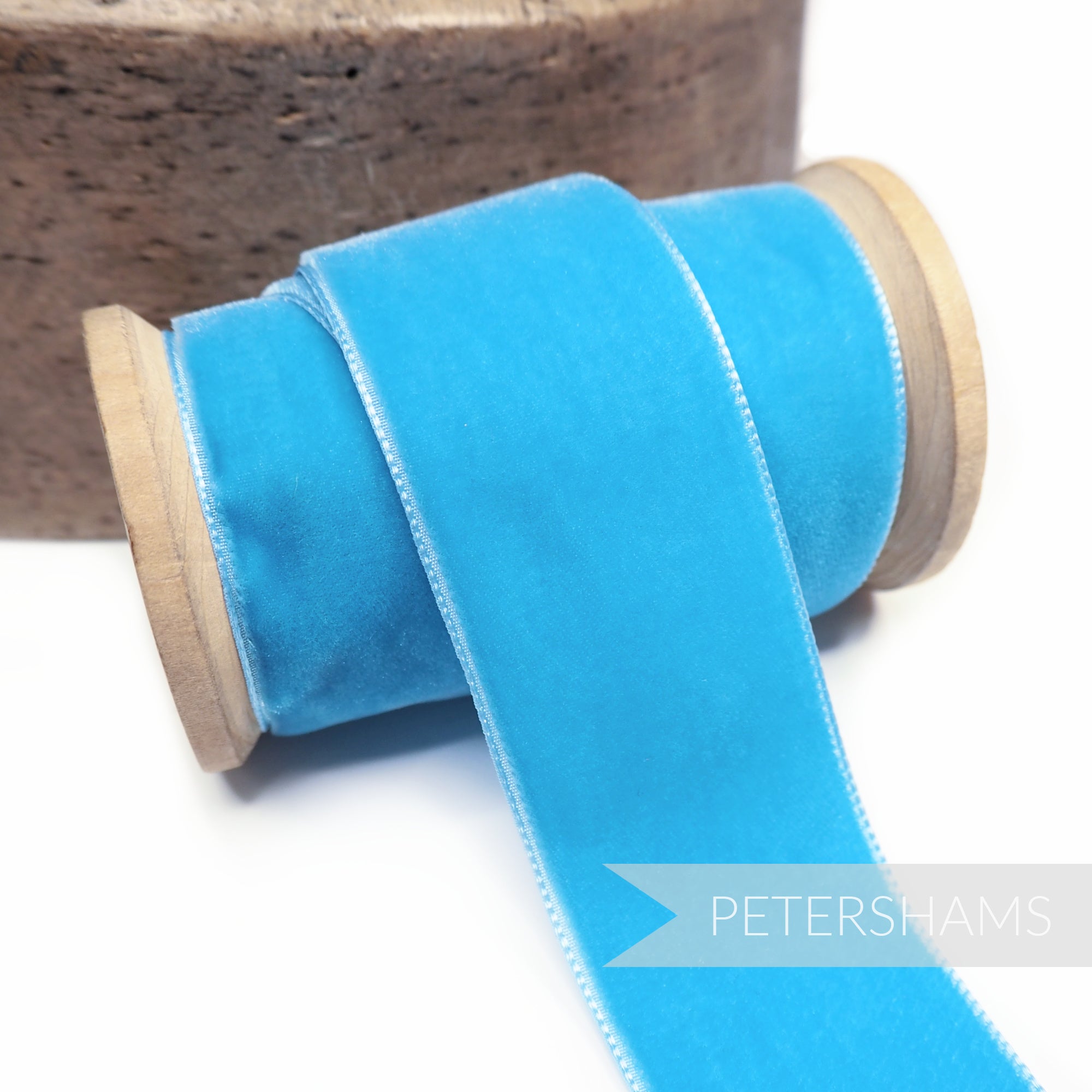 Petershams Millinery Supplies 36mm turquoise French velvet ribbon on a wooden spool for millinery and craft projects.