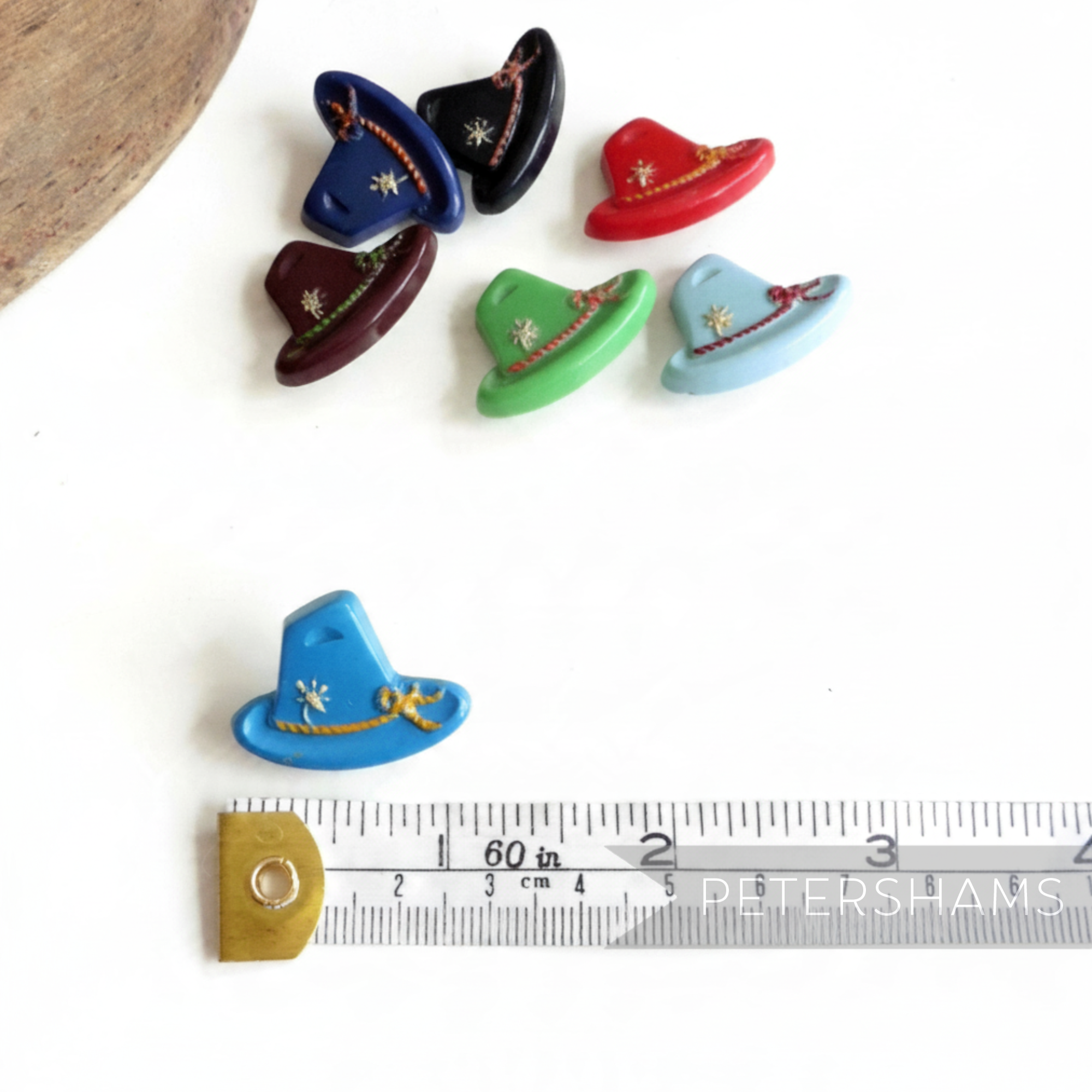 Petershams Millinery Supplies vintage 1940s Alpine hat buttons in various colors with rope and flower relief detail