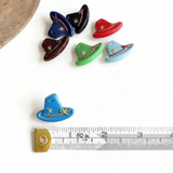 Petershams Millinery Supplies vintage 1940s Alpine hat buttons in various colors with rope and flower relief detail