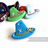 Petershams Millinery Supplies vintage 1940s Alpine hat buttons with floral and rope relief detail in assorted colors.
