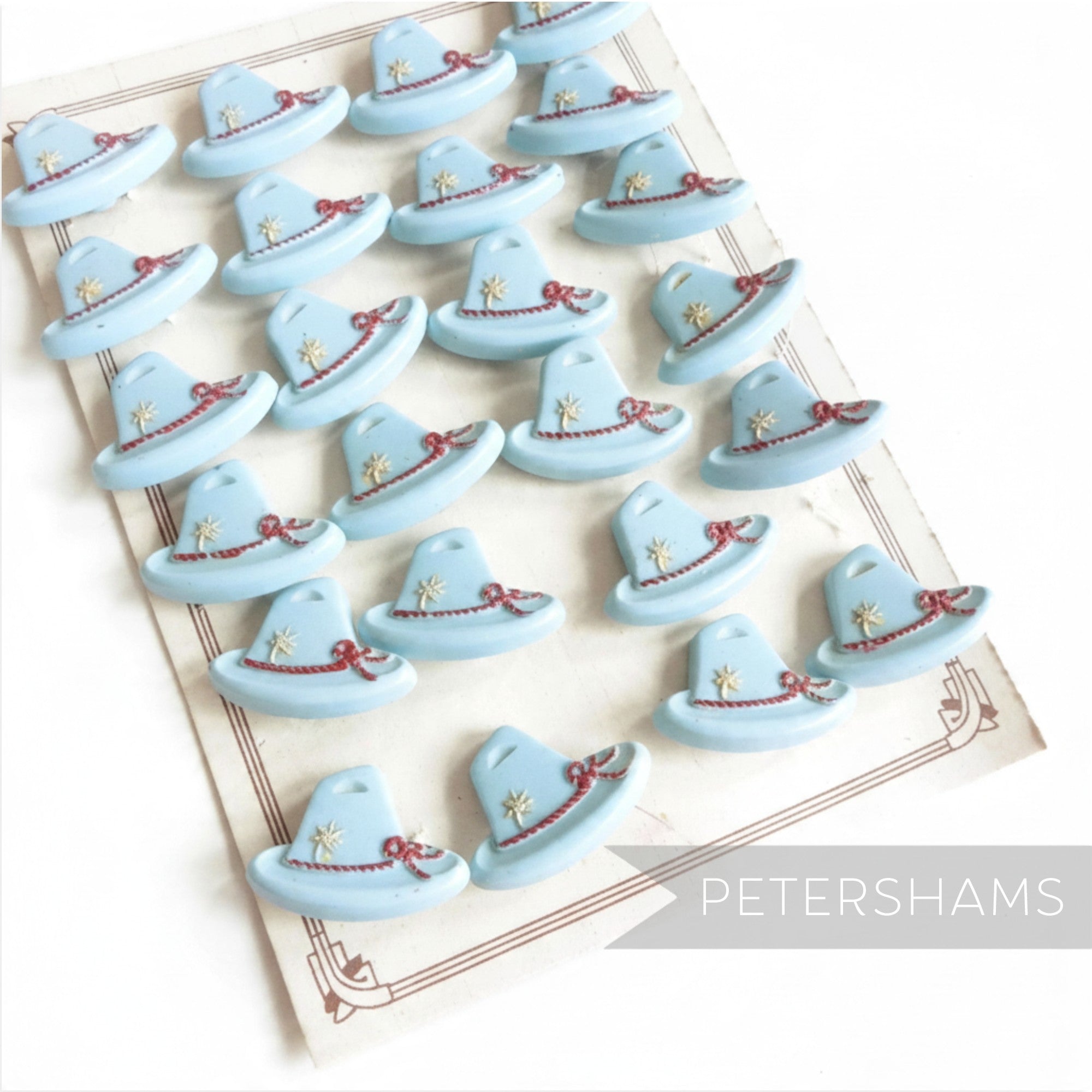 Petershams Millinery Supplies vintage 1940s light blue Alpine hat buttons with rope and flower relief detail