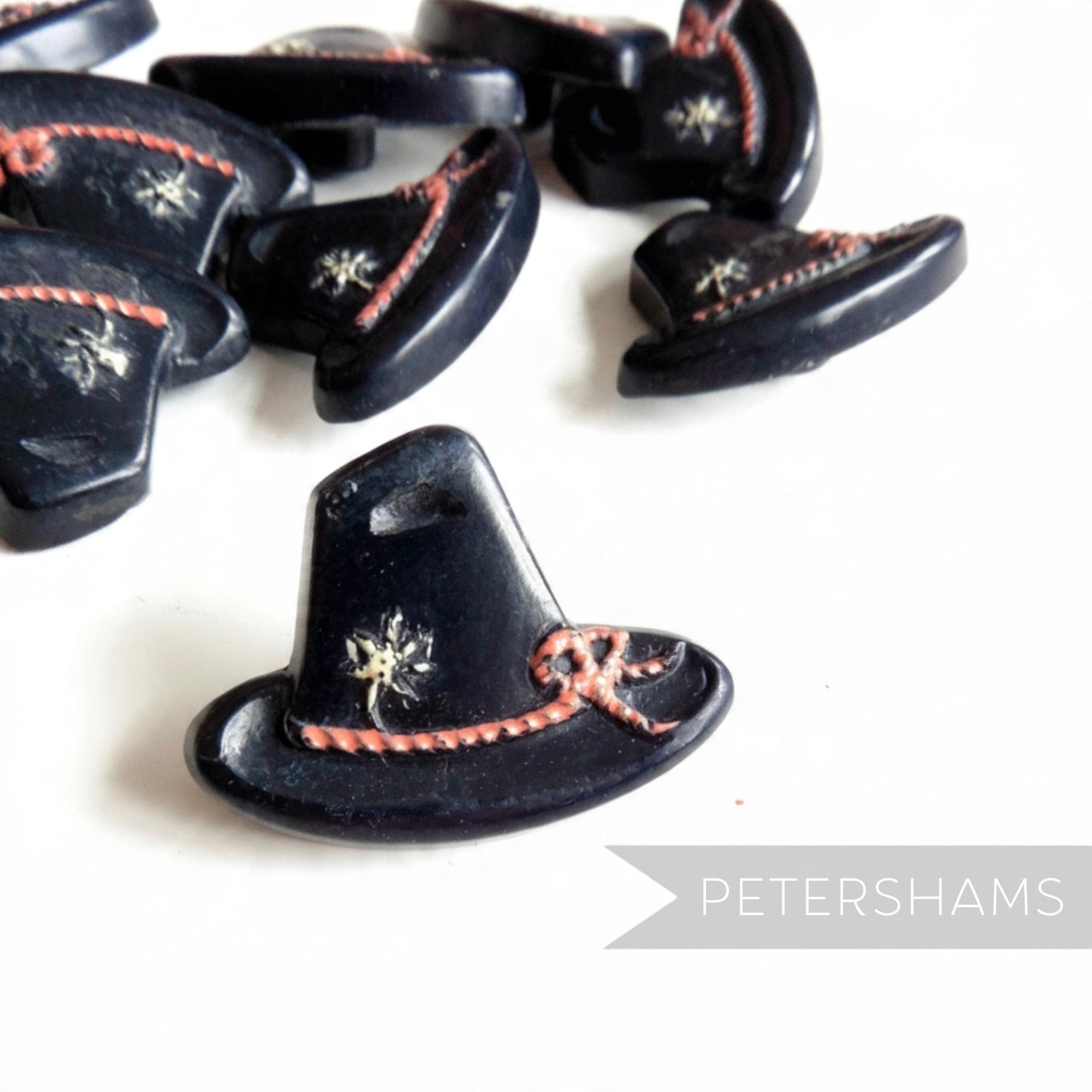 Petershams Millinery Supplies vintage 1940s Alpine hat buttons with rope and flower relief detail in black