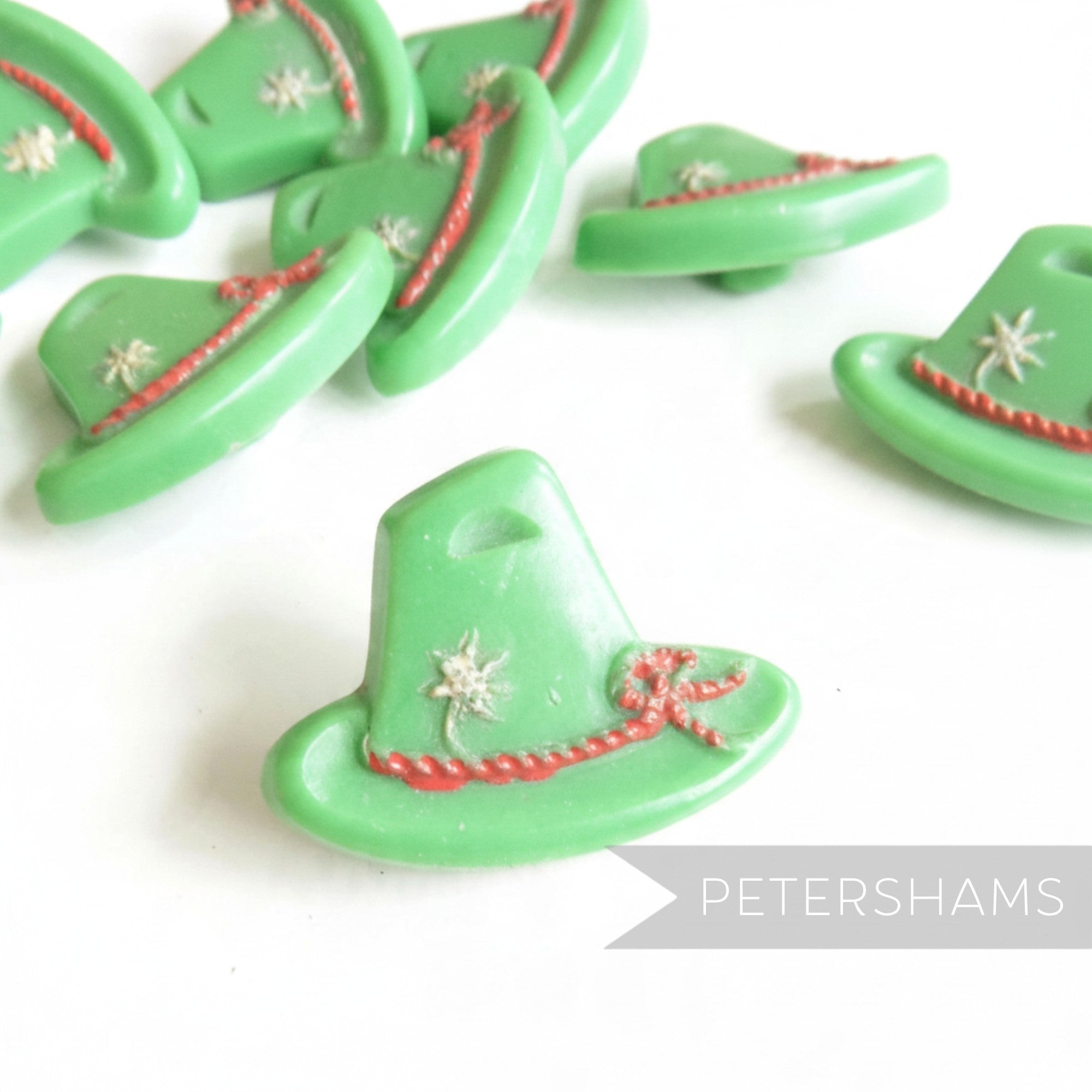 Petershams Millinery Supplies vintage 1940s green Alpine hat buttons with rope and flower relief detail