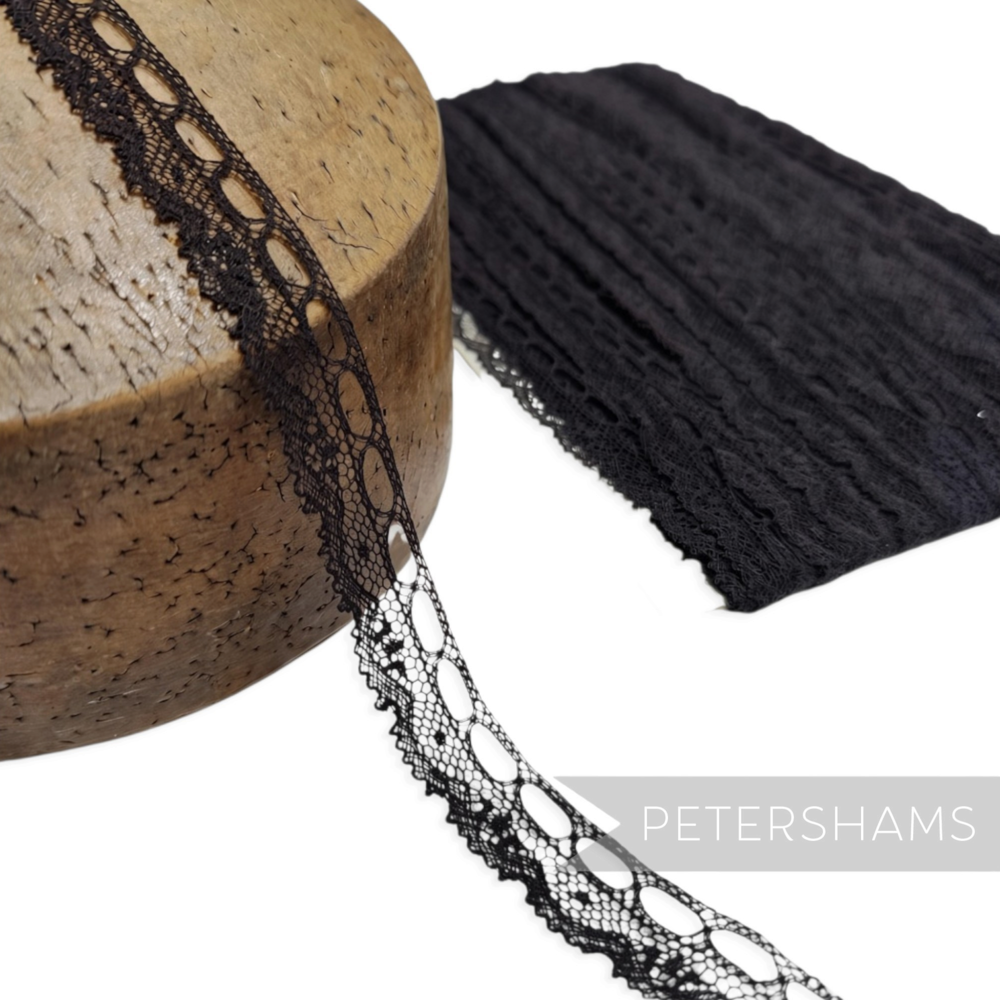 Petershams Millinery Supplies vintage 15mm black cotton lace trim with ribbon holes on a wooden millinery block