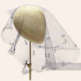 Petershams Millinery Supplies vintage 1930s black honeycomb veiling round with X-shaped accents on a mannequin head
