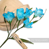 Petershams Millinery Supplies vintage 1960s blue silk freesia flower mount with wired stems and green leaves.