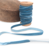 Petershams Millinery Supplies vintage blue velvet ribbon on a wooden spool next to a millinery hat block.