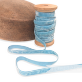 Petershams Millinery Supplies vintage light blue 10mm rayon velvet ribbon on a wooden spool next to a hat block