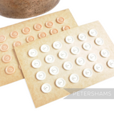 Petershams Millinery Supplies vintage 1940s 19mm two-hole buttons in white and peach on original display cards