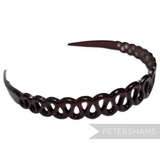 Petershams Millinery Supplies vintage 1980s dark tortoise shell plastic children's headband with squiggle design and tooth grips.