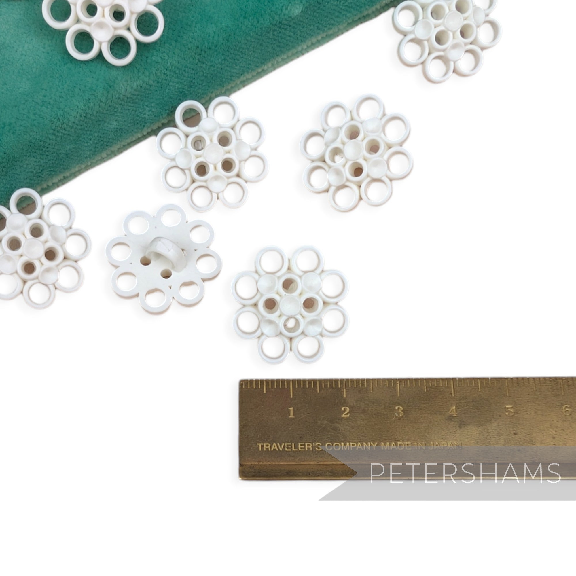 Petershams Millinery Supplies vintage 1960s white plastic shank buttons with circular pattern in a pack of ten