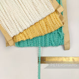 Petershams Millinery Supplies vintage 1950s English cotton Nottingham guipure lace trim in white, yellow, and Jade.