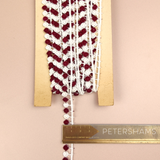 Petershams Millinery Supplies vintage 1950s Austrian 11mm cotton guipure lace trim in off-white and burgundy dots