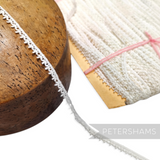 Petershams Millinery Supplies 7mm vintage English cotton Nottingham guipure lace trim with a delicate leafy design.