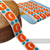 Petershams Millinery Supplies vintage 26mm woven cotton ribbon with orange and blue bubbly pattern on white background