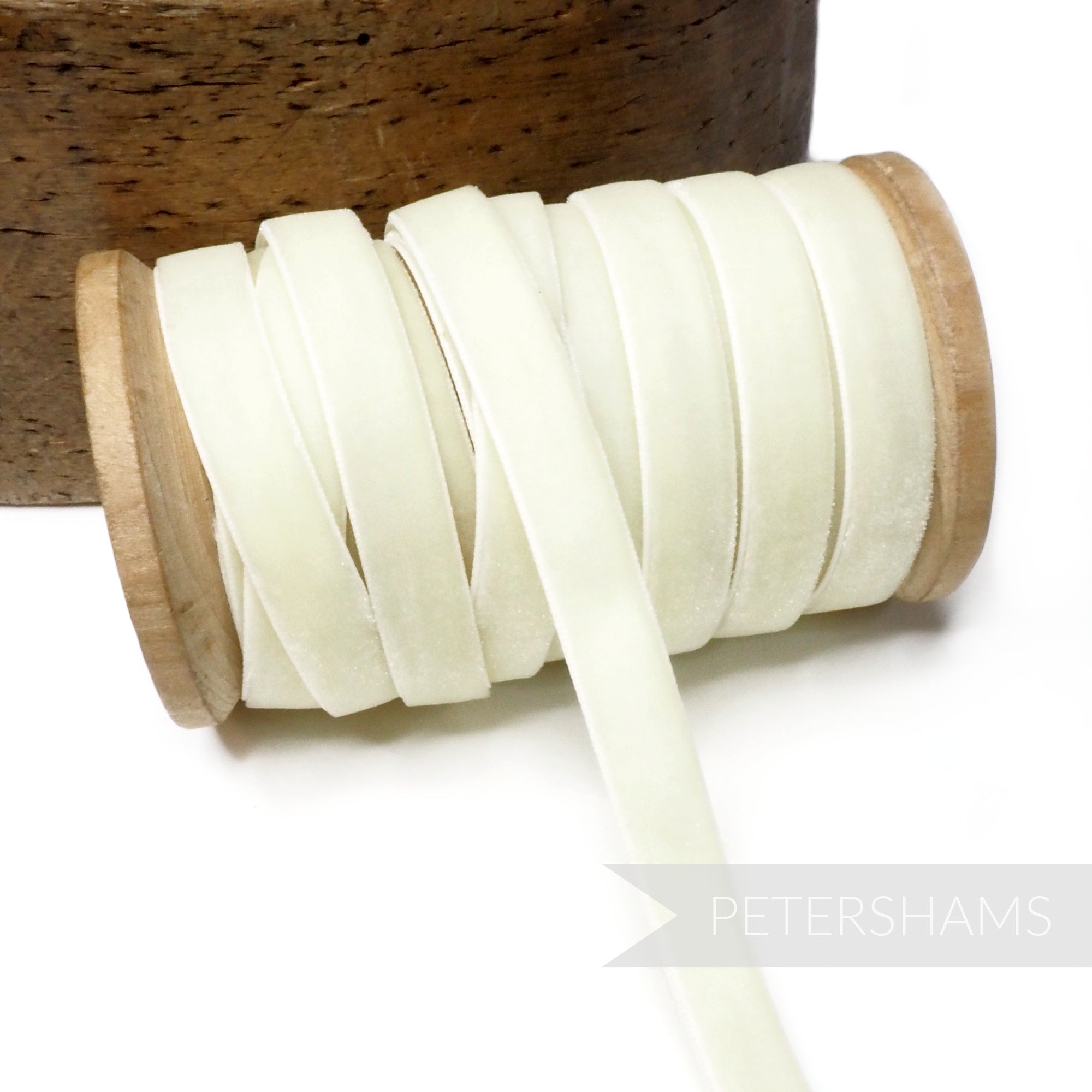 Petershams Millinery Supplies 10mm vintage ivory velvet ribbon on a wooden spool for sewing and millinery projects.