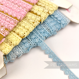 Petershams Millinery Supplies vintage 11mm daisy lace trim in pastel pink, yellow, and blue on cardboard spools