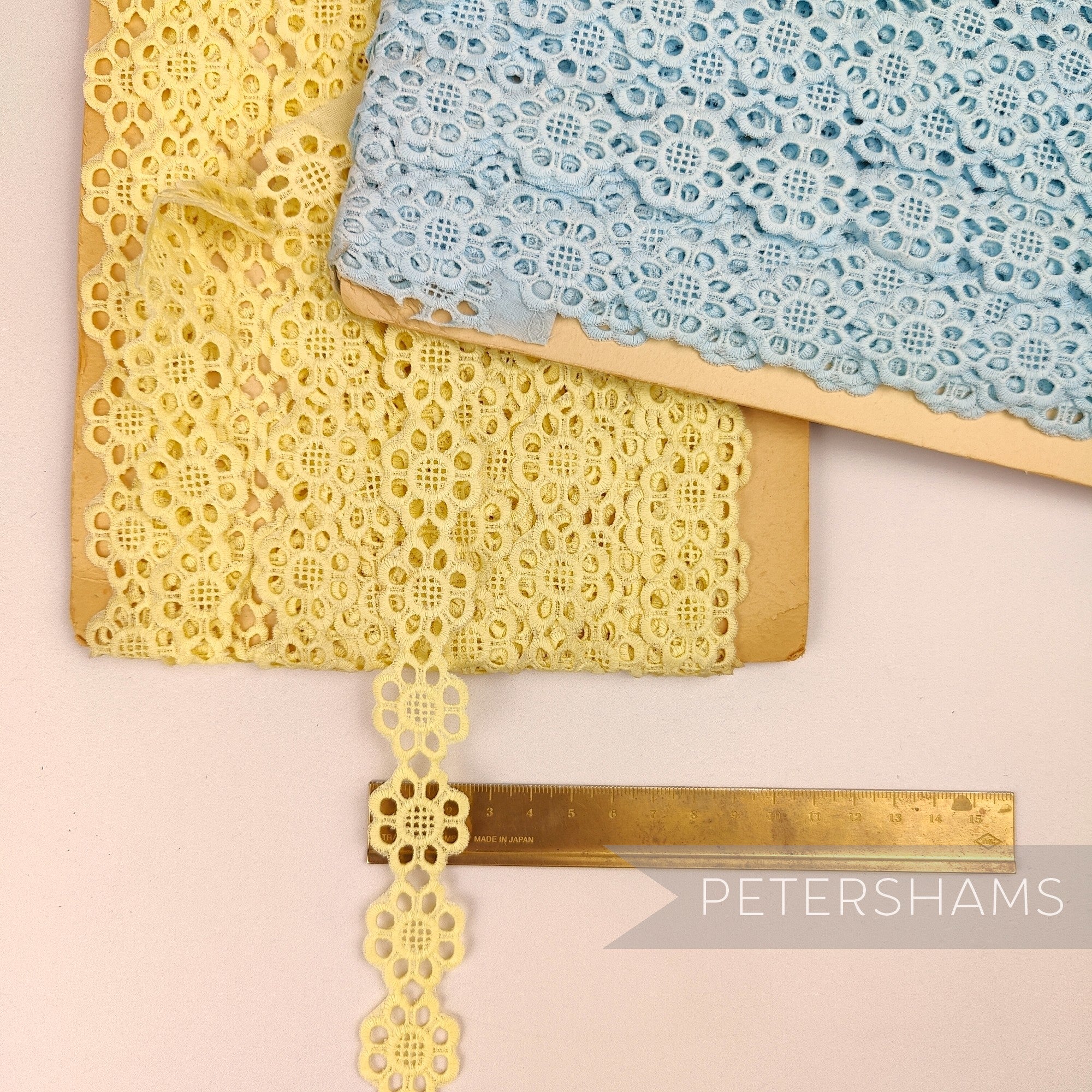 Petershams Millinery Supplies vintage Austrian daisy lace trim in yellow and blue on wooden spools with ruler