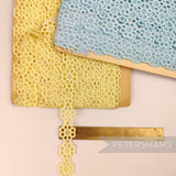 Petershams Millinery Supplies vintage Austrian daisy lace trim in yellow and blue on wooden spools with ruler