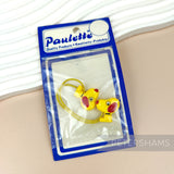 Petershams Millinery Supplies vintage yellow Paulette cartoon dog hair bobble in original packaging