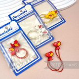 Petershams Millinery Supplies vintage Paulette cartoon dog hair bobbles in red, white, and yellow on original cards