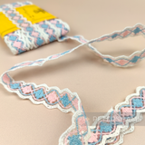 Petershams Millinery Supplies 22mm vintage cotton and nylon trim in a pink, blue, and white diamond weave pattern.