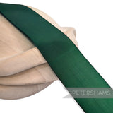 Petershams Millinery Supplies 50mm vintage dark green nylon ribbon on a wooden millinery block