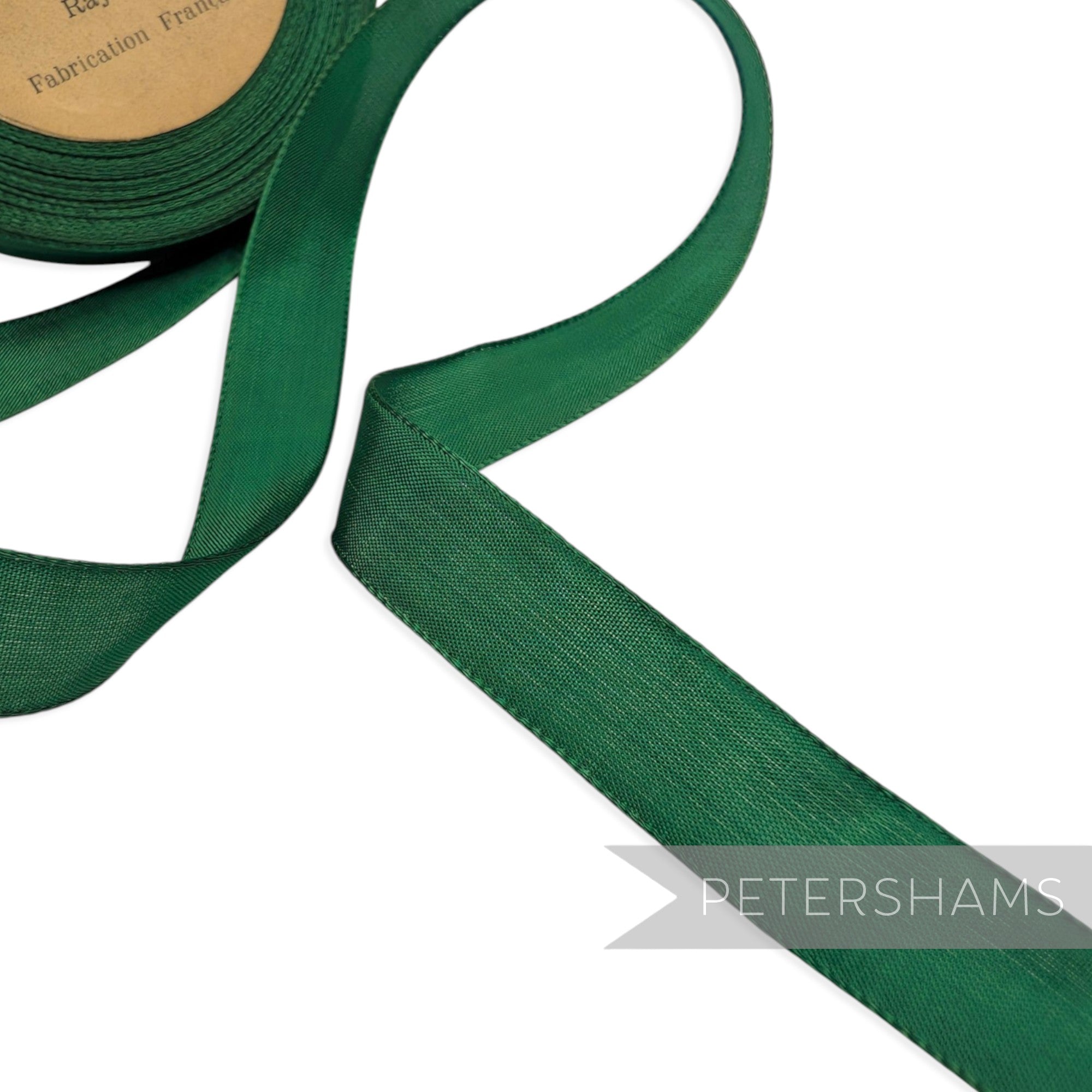 Petershams Millinery Supplies vintage dark green rayon taffeta ribbon roll with fine woven satin edges.