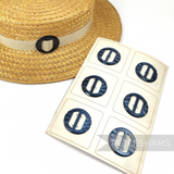 Petershams Millinery Supplies vintage 40mm pearly grey circle buckle with carved effect on a straw hat and display card