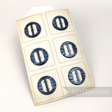Petershams Millinery Supplies vintage 40mm pearly grey circle buckles with carved effect on original display card.